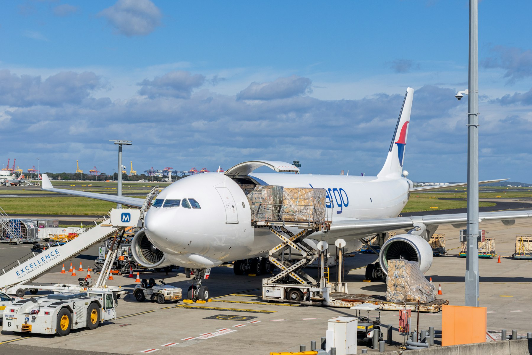 Cargo aircraft being loaded with freight on the tarmac